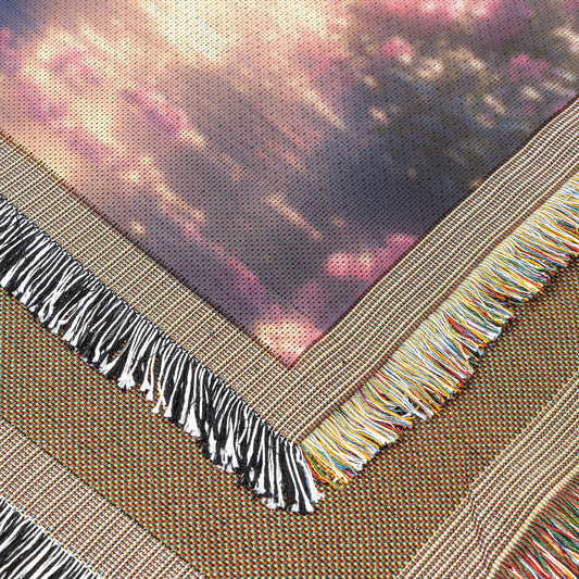 Two Peacocks by Glowing River with Lush Greenery and Vibrant Flowers Under Twilight Light Woven Throw Blanket - Awakening Righteousness