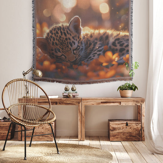 Young Leopard Cub Playfully Rolling in Meadow with Glowing Flowers and Soft Sunlight Woven Throw Blanket - Awakening Righteousness
