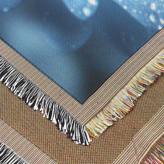 CloseUp of Dew Kissed Blue Flower with Vibrant Orange Center Woven Throw Blanket for Home Decor - Awakening Righteousness
